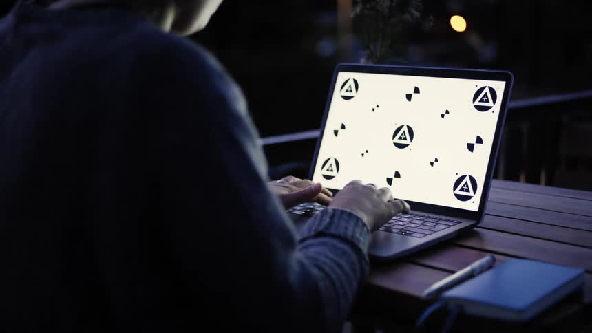 A person is typing on their laptop