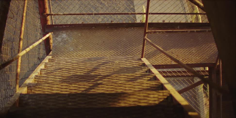 A staircase with handrails and a fence