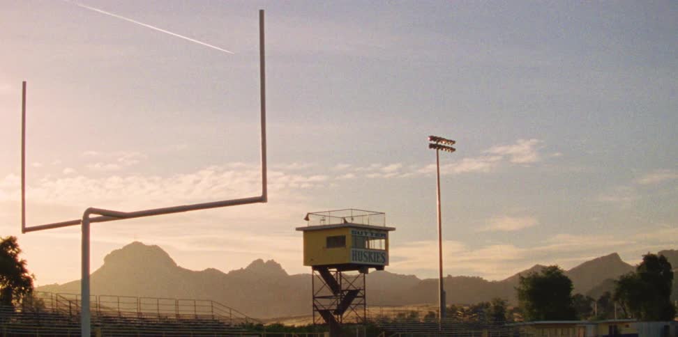 The football field is empty during the day