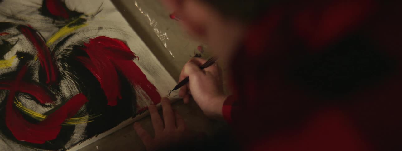 Artist paints the artwork with a paint brush