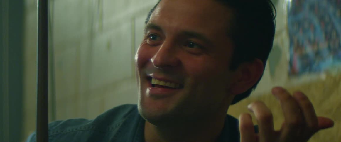 Man listens with a smile then talks and laughs