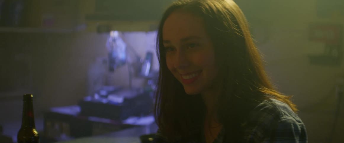 Young woman on a date in a bar talks laughing and smiling to a man