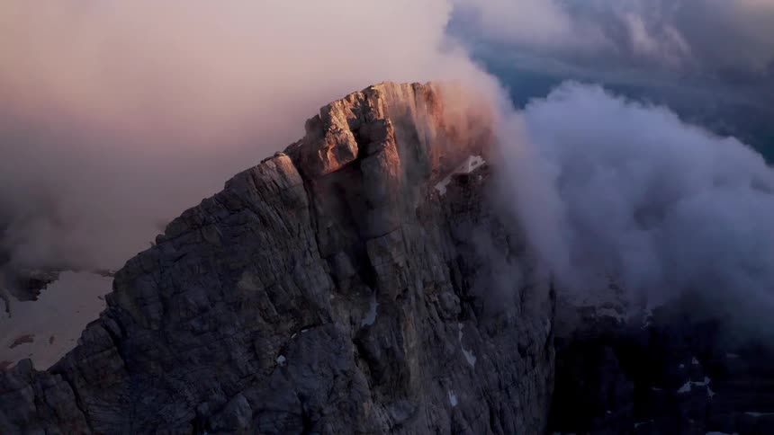 Aerial view of the top of a mountain with clouds all around