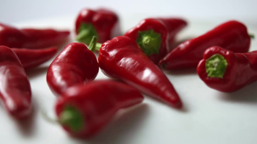 Red peppers rotating on a round white tray