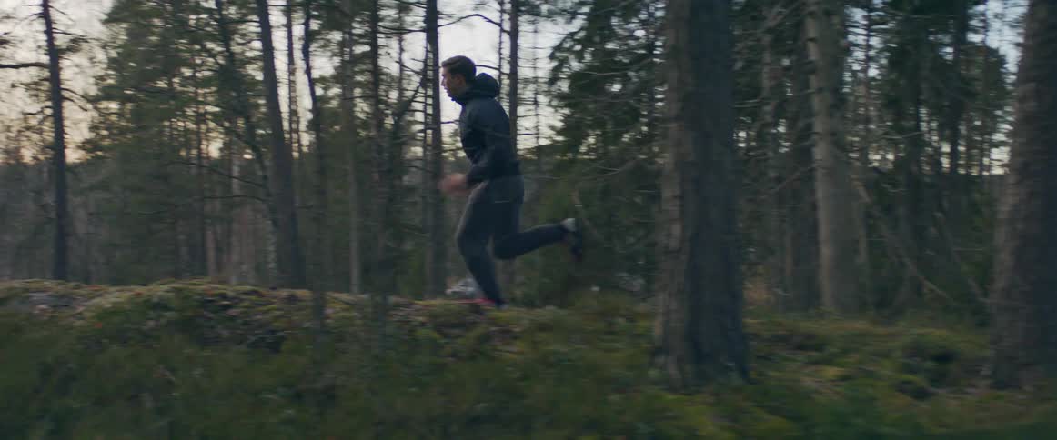 A man runs through the trees