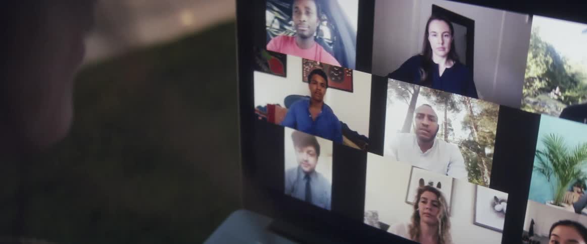 Woman talking to several people on a video call in a laptop