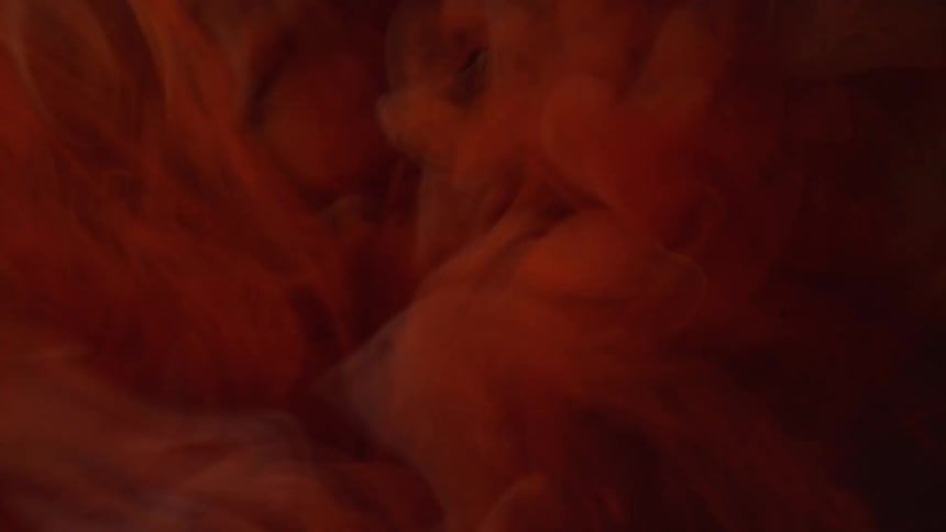 Swirling red liquid in the dark