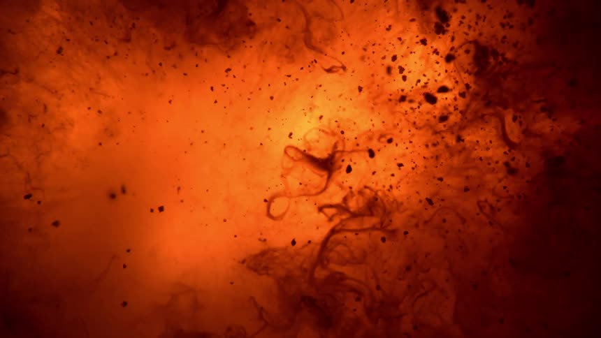 Bright yellow and orange liquid lava like substance forminginto bubbles