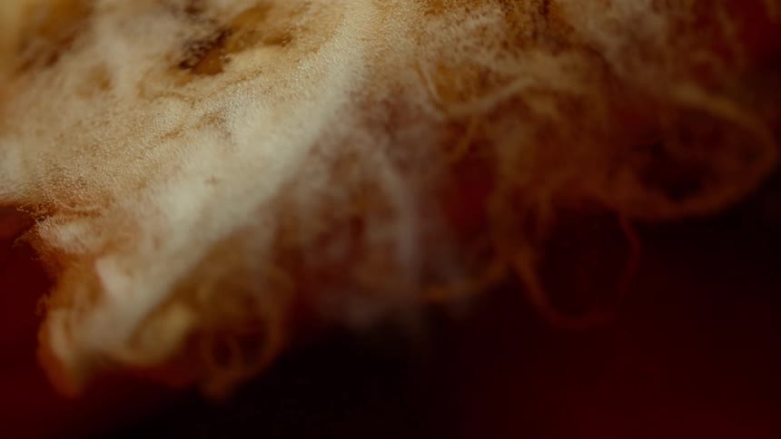 Liquid is poured into another liquid forming bubbles and foam as it dissipates