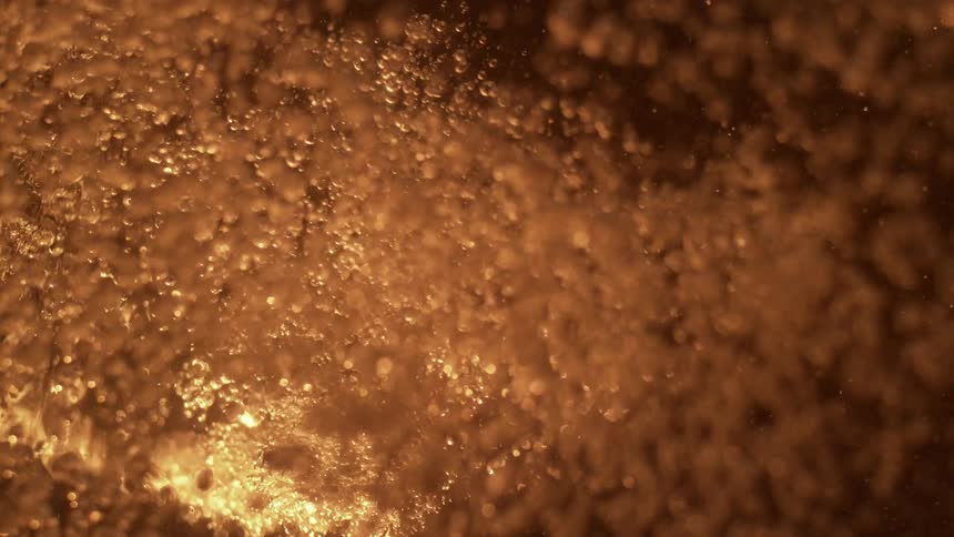 A liquid starts to boil and cover the surface