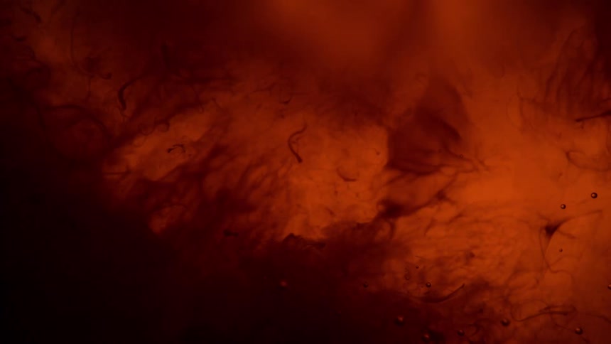 Swirling dark orange liquid