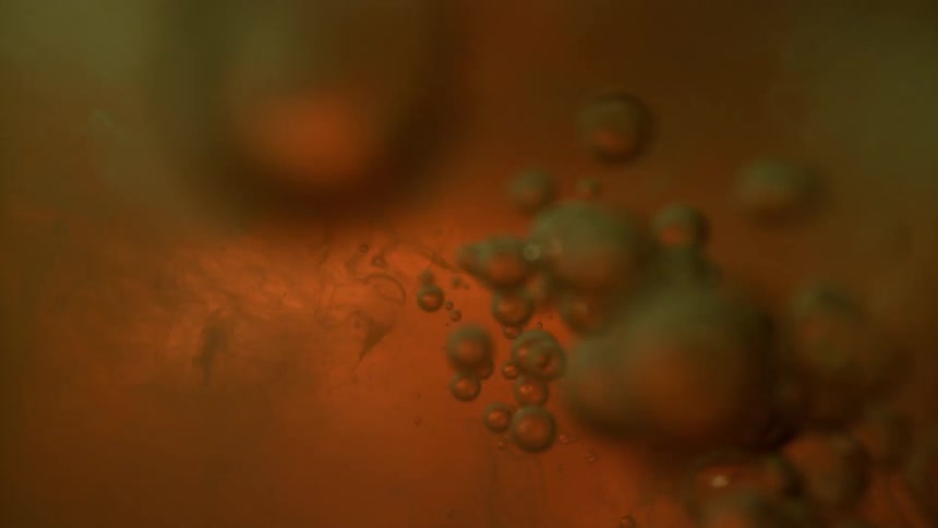 Bubbles floating in orange and red liquid