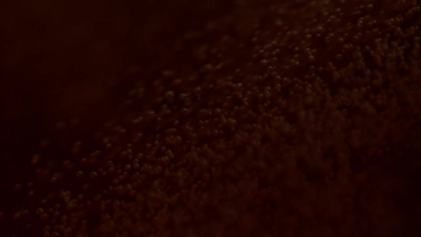 A brown liquid with bubbles