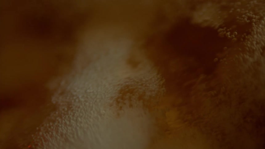 Bubbles floating in amber liquid