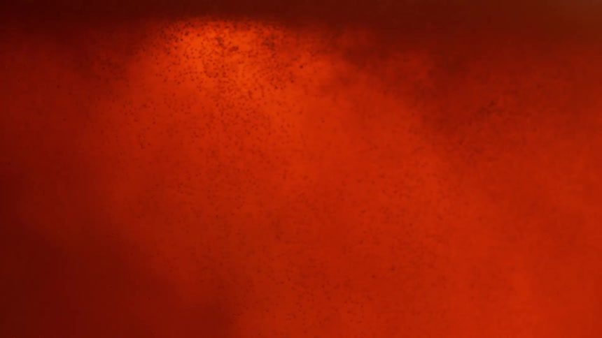Bright orange and yellow liquid forming bubbles and waves