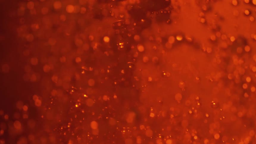 Bubbling amber liquid in the dark