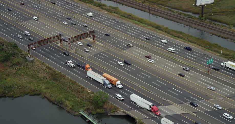 Cars and shipping trucks driving down a freeway