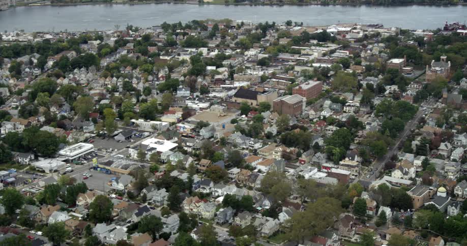Aerial view of a small town with houses and shops next to a lake