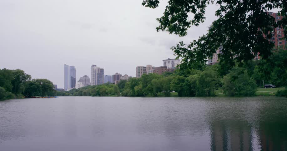 Dense trees separate a river from downtown