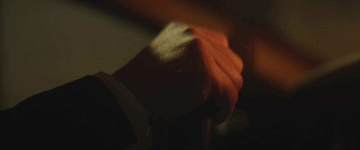 Mans hand holds the steering wheel to make the vehicle go in a particular direction