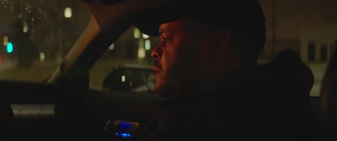 A man is driving a car at night