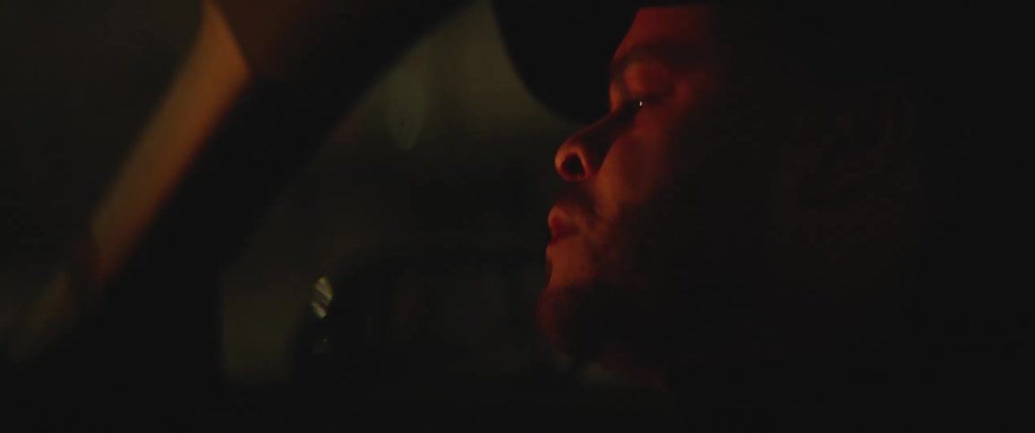 A man is driving a car at night