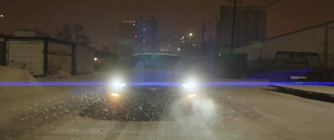 A car is driving at night in winter