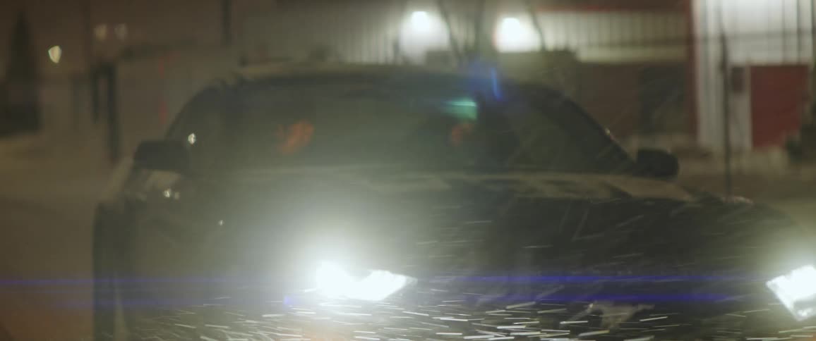 Two humans driving a car through the snow