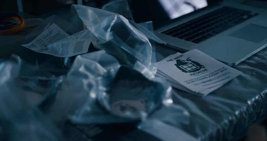 Desk full of bags of masks with leaflets