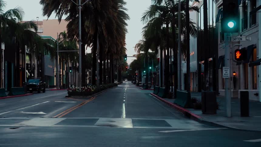 A city street with stores on it and vehicle parked