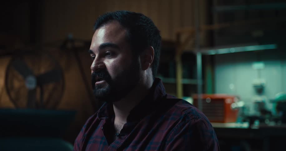 A man talking in his garage
