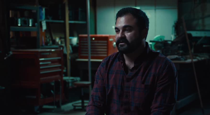 A man is sitting in a garage