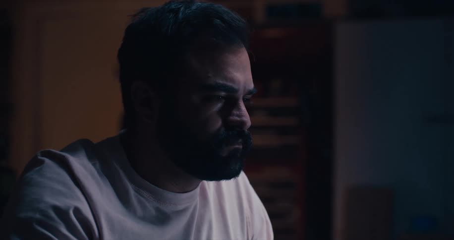 A man sitting inside concentrating