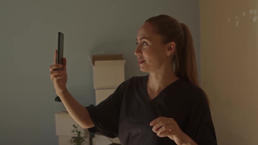 Woman talking on her phone in an empty room