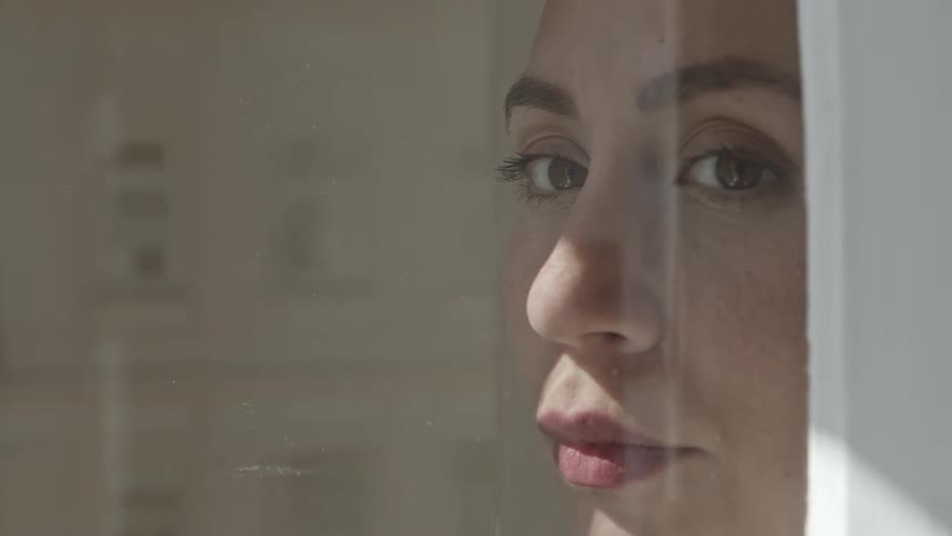 A woman is looking out the window