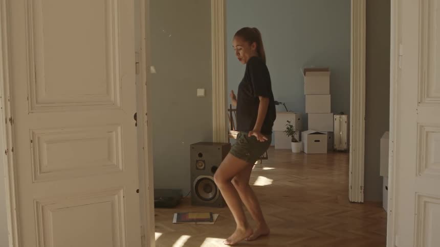 Woman dancing in her hallway