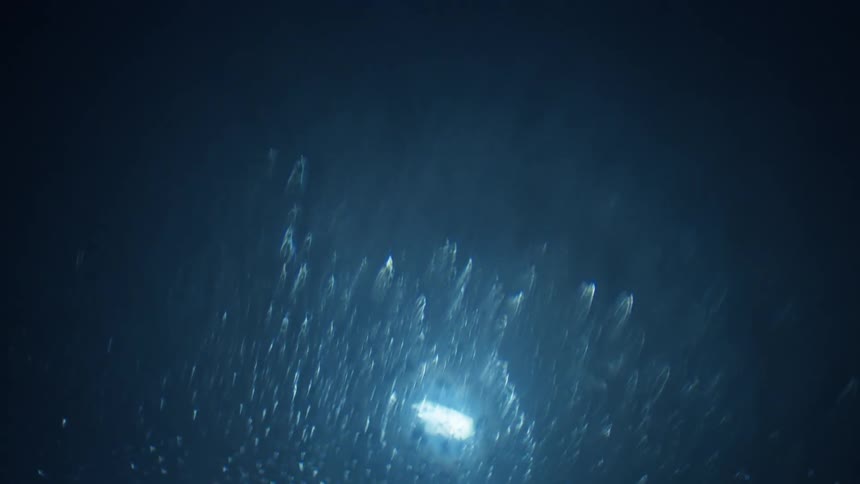 Light shining on water droplets on a window while the camera changes focus and alters the drops appearance