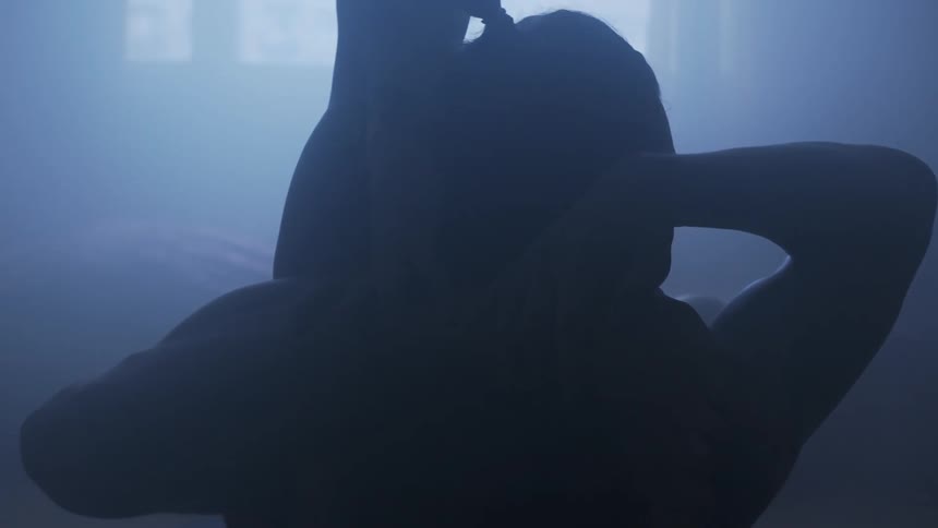 A person stretching and putting their foot behind their head