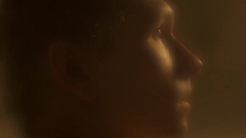 A profile of a humans face with very little lighting