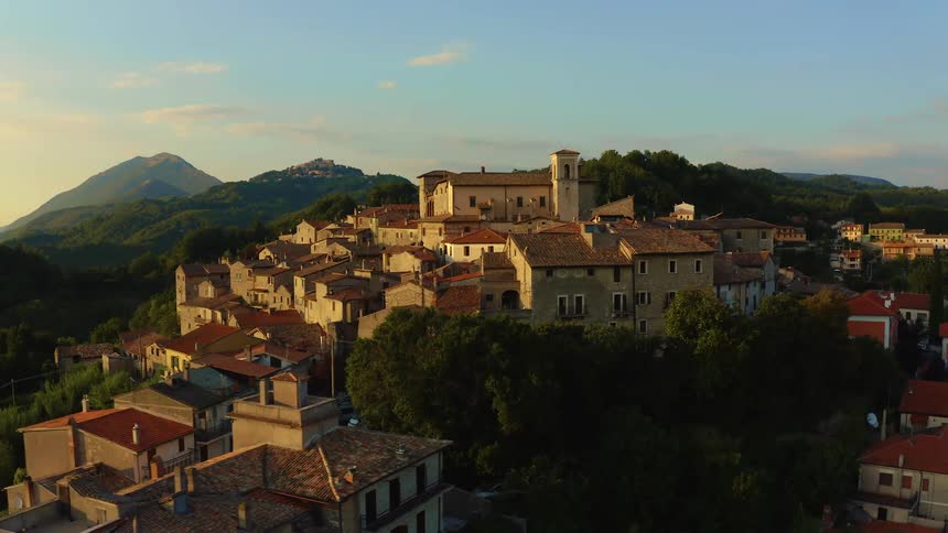 A small town is on the mountain top golden hour