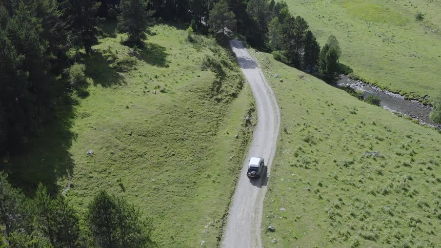 A car is driving in a rural area