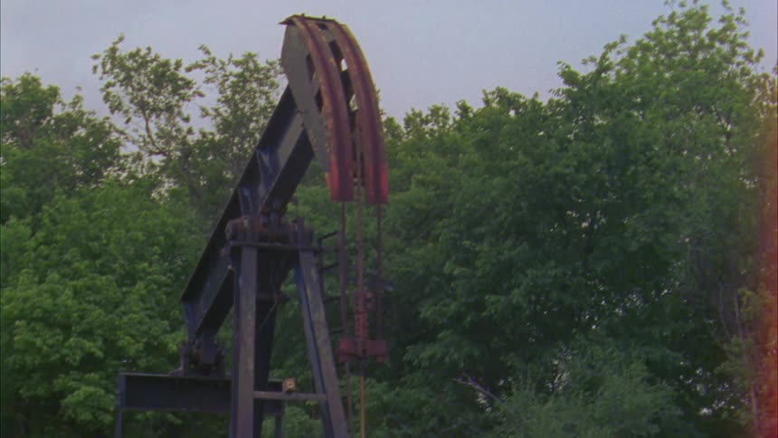 Old oil miner in grasslands fenced off