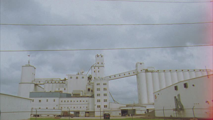 The factory is behind the long fence