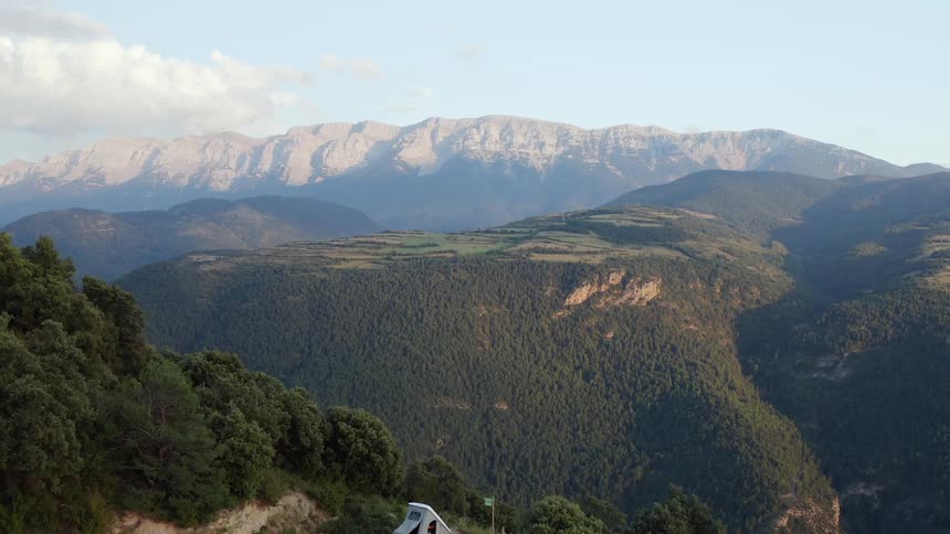 Wide aerial view of mountain range against blue skies during the day