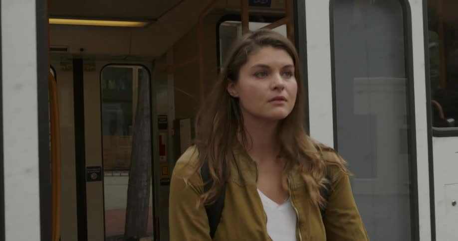 A woman exits the train
