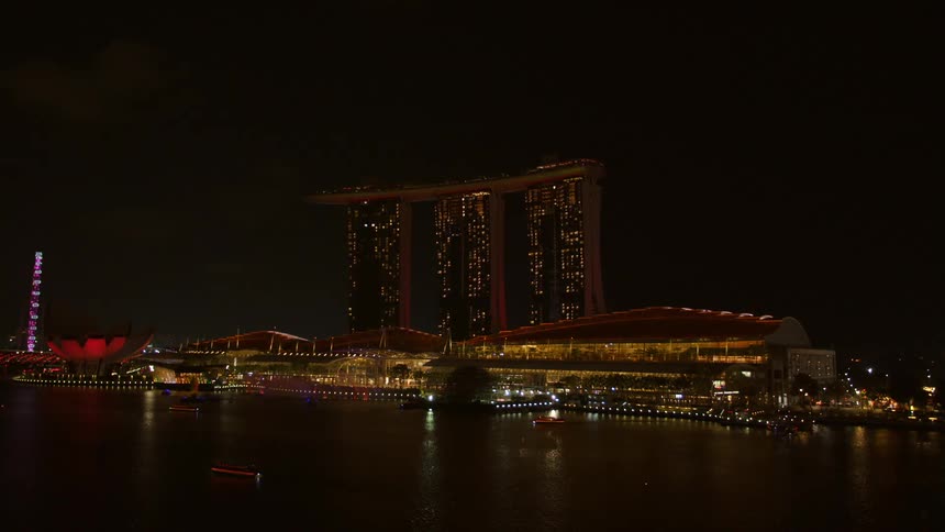 A large elaborately designed building on the coast at night