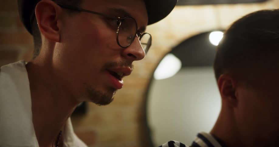 A man talks to a man beside him