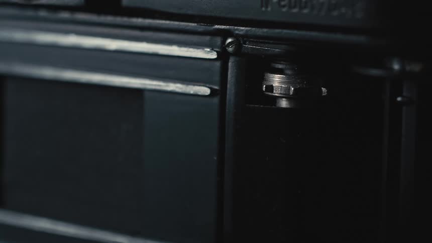 A metal rotating knob on a camera