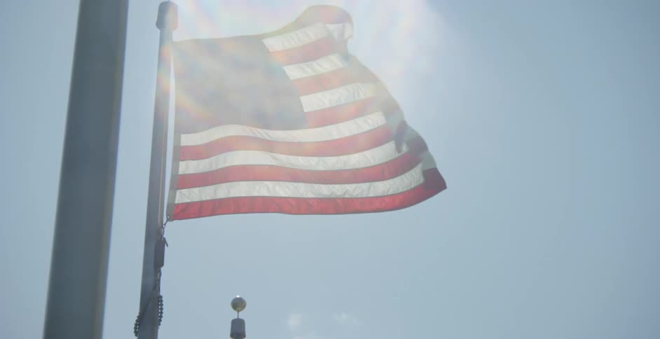 American flags waving in the wind on a sunny day