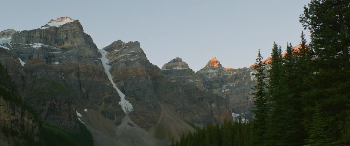 The sun is setting above the mountain range